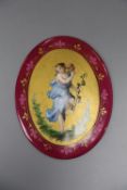 A Continental oval porcelain plaque depicting a girl, height 12.5cm