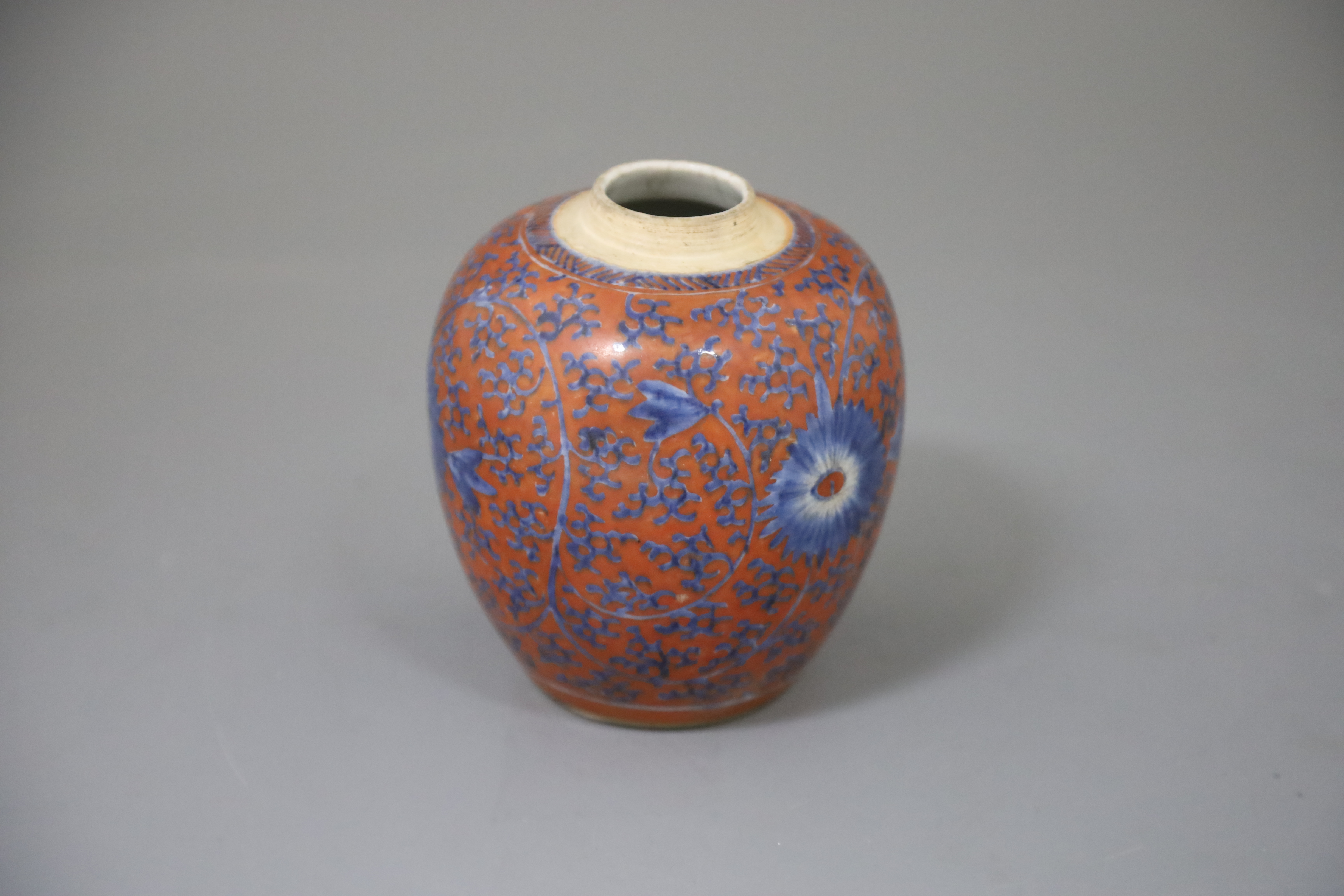 A Chinese coral red ground underglaze blue jar, Kangxi period, painted with flowerheads and - Image 2 of 4