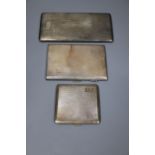 Three assorted mid 20th century silver engine turned cigarette cases, largest 16.8cm, gross 18oz.