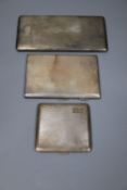 Three assorted mid 20th century silver engine turned cigarette cases, largest 16.8cm, gross 18oz.