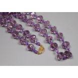 A single strand facetted purple paste bead necklace with 14k yellow metal clasp, 53cm.