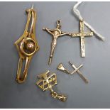 An Edwardian 9ct scroll brooch, 4cm, two 14k small pendants, a 9ct cross pendant and a 12k gold