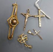 An Edwardian 9ct scroll brooch, 4cm, two 14k small pendants, a 9ct cross pendant and a 12k gold