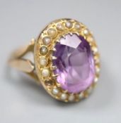 An early 20th century 9ct, amethyst and split pearl set oval dress ring, size N, gross 4.8 grams, (
