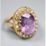 An early 20th century 9ct, amethyst and split pearl set oval dress ring, size N, gross 4.8 grams, (