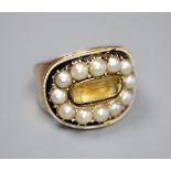 A George III yellow metal, black enamel, split pearl and foil backed citrine set oval mourning ring,