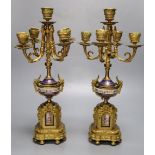 A pair of 19th century French ormulu and porcelain five light candelabra, mounts in the style of