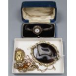 Two Victorian gilt metal brooches, a similar locket pendant on chain and a lady's silver cased wrist