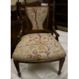 A late Victorian marquetry inlaid rosewood low seat chair