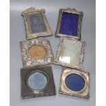 Six assorted early 20th century repousse silver mounted photograph frames, largest 19.3cm.