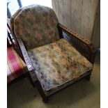 A pair of early 20th century oak bergere armchairs