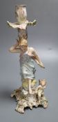 A German porcelain candlestick with lady and cherub, height 26.5cm (a.f.)CONDITION: Figural