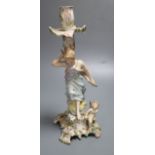 A German porcelain candlestick with lady and cherub, height 26.5cm (a.f.)CONDITION: Figural