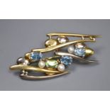 An early 1990's 18ct two colour gold and gem set modernist brooch, 5cm, gross 11.7 grams.