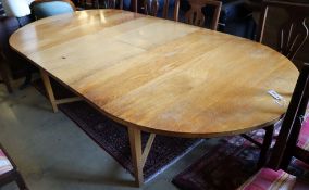 A contemporary oak extending dining table, length 240cm extended, depth 120cm, height