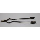 A pair of antique white metal sugar tongs in the form of fire tongs, indistinct marks, 12.4cm, 14