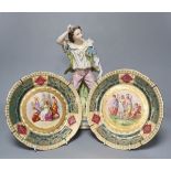 A 19th century French bisque figure, 32cm and two Vienna-style wall plates, 22cm