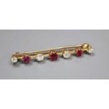 A yellow metal, four stone diamond and three stone ruby set bar brooch, 41mm, gross 3.6 grams.