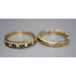 A modern 18ct gold, sapphire and diamond half hoop ring, size K and an 18ct two colour gold band,