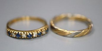 A modern 18ct gold, sapphire and diamond half hoop ring, size K and an 18ct two colour gold band,