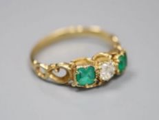 A Victorian style yellow metal (stamped 18ct), two stone emerald and single stone diamond set