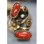 An Arts & Crafts yellow and white metal and two stone cabochon coral set triple shank dress ring,