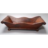 A Victorian mahogany cheese coaster, with scroll ends, 36 x 19cm