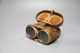 A cased pair of ivory mounted binoculars, leather cased