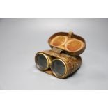 A cased pair of ivory mounted binoculars, leather cased