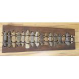 A xylophone formed from Stone Age flints, length 60cm