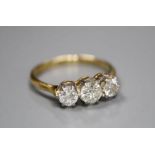 An 18ct and plat, three stone diamond ring, size O, gross 2.7 grams.