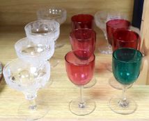 A set of five vine etched cut champagne glasses, a set of five cranberry glass bowled wine glasses