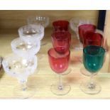 A set of five vine etched cut champagne glasses, a set of five cranberry glass bowled wine glasses