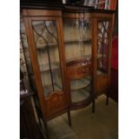 An Edwardian marquetry inlaid mahogany bow fronted display cabinet