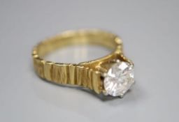 A modern textured 18ct gold and solitaire diamond ring, the stone weighing 0.90ct, size L, gross 4.1