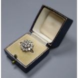 A white metal (stamped 18ct) and domed diamond cluster ring, size J, gross 4.7 grams.