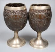 A pair of 19th century white metal mounted coconut cups, indistinct marks, 16.6cm.