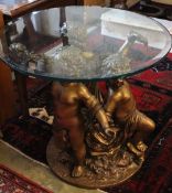 A cast gilt metal glass top cherub centre table, 81cm diameter