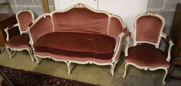 A Louis XV style cream and gilt painted carved wood framed canape and a pair of open armchairs,