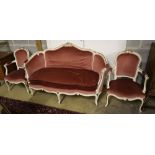 A Louis XV style cream and gilt painted carved wood framed canape and a pair of open armchairs,