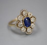 An early to mid 20th century 18ct, sapphire and diamond set quatrefoil cluster ring, size L, gross