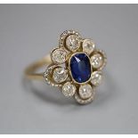 An early to mid 20th century 18ct, sapphire and diamond set quatrefoil cluster ring, size L, gross