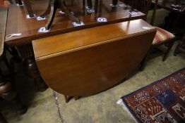 A mid century design G Plan style teak gateleg dining table, width 132cm depth 154cm extended