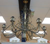 A wrought metal six branch ceiling light, 78cm diameter
