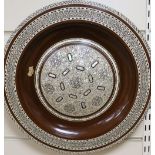 A circular polished wood wall plate with micro mosaic inlays in mother of pearl, Moroccan style,
