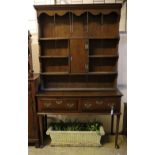 An 18th century oak low dresser with later boarded plate rack, width 128cm depth 46cm height 216cm