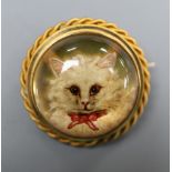 A Victorian yellow metal and Essex crystal set circular brooch, decorated with the head of a cat,