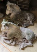 A pair of reconstituted stone recumbent horse garden ornaments, length 62cm