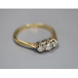 An 18ct & Pt, three stone diamond ring, size M/N, gross 1.8 grams.