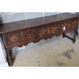 A late 17th century style oak dresser base fitted three geometrically moulded frieze drawers,
